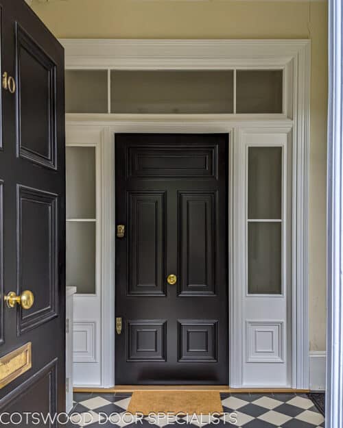 Georgian front firedoor. Large black Georgian style front door and sidelight door frame. Fire rated (fd30) door with fire rated glass and surround. Door frame is made to replicate the original door mouldings. Door has high secuirty banham locks in brass. Door installation blends seamlessly with original architrave features