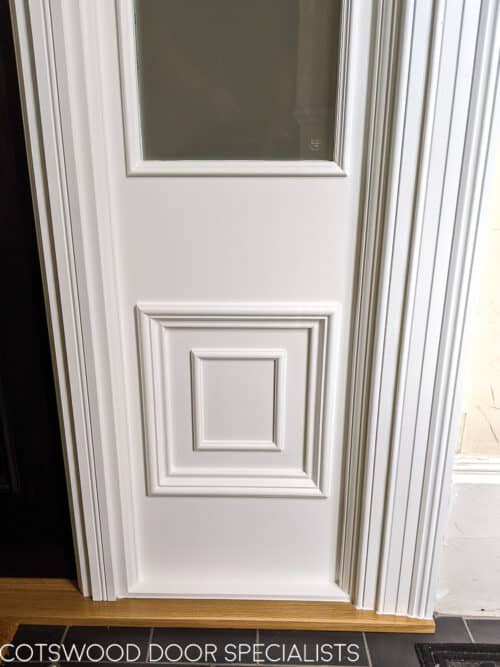 Georgian front firedoor. Large black Georgian style front door and sidelight door frame. Fire rated (fd30) door with fire rated glass and surround. Door frame is made to replicate the original door mouldings. Door has high secuirty banham locks in brass. Door installation blends seamlessly with original architrave features