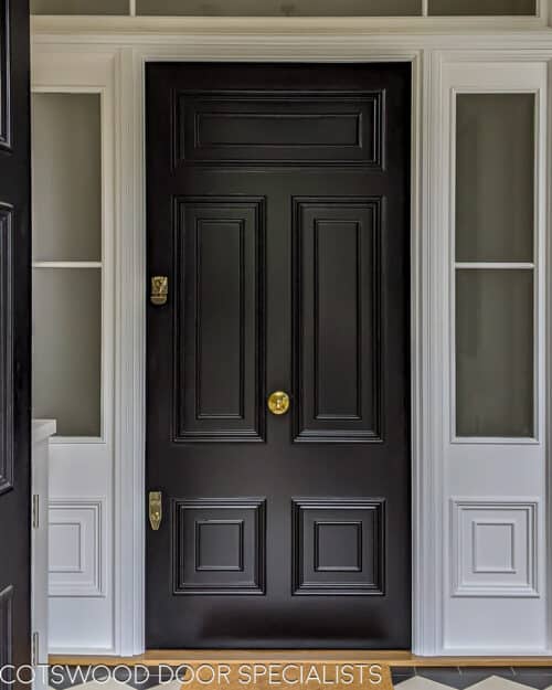 Georgian front firedoor. Large black Georgian style front door and sidelight door frame. Fire rated (fd30) door with fire rated glass and surround. Door frame is made to replicate the original door mouldings. Door has high secuirty banham locks in brass. Door installation blends seamlessly with original architrave features