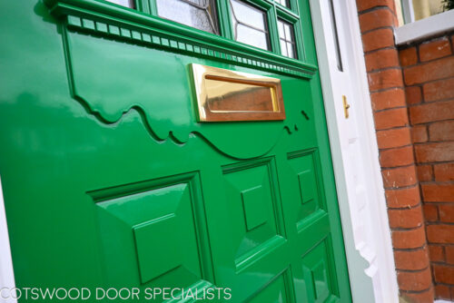 ornamental Edwardian front door with stained glass. A decorative 17 light Edwardian front door with decorative features such as a shelf and dentil block and an apron of which the letterplate is fixed too. The frame is a large frame with sidelights and glazing above the door. The door frame is very ornamental with pilasters (detailed moulding forming columns each side of the door) supporting a decorative transom with detailed mouldings and a dentil block. The stained glass is a art nouveau design featuring roses. door and frame are a replica of the orignal Edwardian joinery. Handmade in Accoya wood and fitted with multipoint locking. detailed picture door mouldings