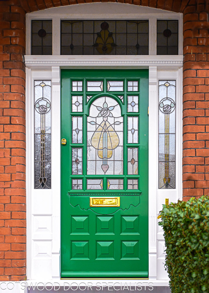 ornamental Edwardian front door with stained glass. A decorative 17 light Edwardian front door with decorative features such as a shelf and dentil block and an apron of which the letterplate is fixed too. The frame is a large frame with sidelights and glazing above the door. The door frame is very ornamental with pilasters (detailed moulding forming columns each side of the door) supporting a decorative transom with detailed mouldings and a dentil block. The stained glass is a art nouveau design featuring roses. door and frame are a replica of the orignal Edwardian joinery. Handmade in Accoya wood and fitted with multipoint locking
