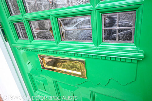 ornamental Edwardian front door with stained glass. A decorative 17 light Edwardian front door with decorative features such as a shelf and dentil block and an apron of which the letterplate is fixed too. The frame is a large frame with sidelights and glazing above the door. The door frame is very ornamental with pilasters (detailed moulding forming columns each side of the door) supporting a decorative transom with detailed mouldings and a dentil block. The stained glass is a art nouveau design featuring roses. door and frame are a replica of the orignal Edwardian joinery. Handmade in Accoya wood and fitted with multipoint locking. detailed picture door mouldings